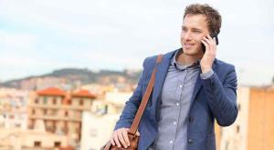 Small_Man talks on phone while traveling abroad