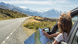 Woman travelling by car holding a map